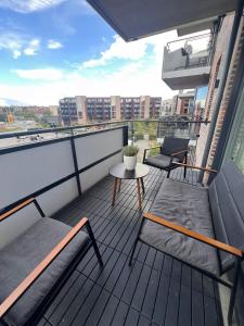 a balcony with two chairs and a table on a building at Cozy private room centrally in Jessheim in Jessheim