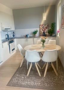 a kitchen with a table and chairs in a room at Cozy private room centrally in Jessheim in Jessheim