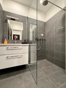 a bathroom with a shower with a glass door at Appartment in Freizeitpark in Wiesloch +34 photos