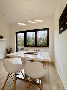 a dining room with a white table and chairs at Appartment in Freizeitpark in Wiesloch