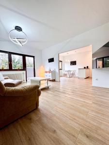 a large living room with a couch and wooden floors at Appartment in Freizeitpark in Wiesloch