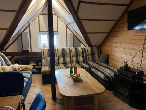 a living room with a couch and a table at Apartmány U Kocoura pod Klínovcem in Kovářská