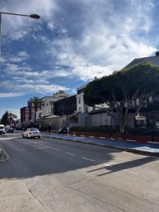 a street with a car driving down the street at The Rooms Lara in Antalya