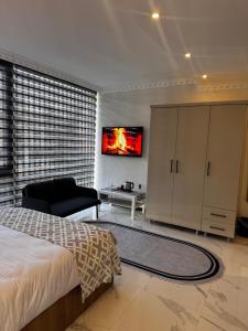 a bedroom with a bed and a tv on a wall at The Rooms Lara in Antalya