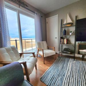 a living room with a view of the ocean at Beachside Condo w Stunning Lake Views in Sheboygan