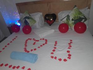 a bed with a heart made out of red hearts at Aqua Garden Building in Nyali