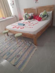 a bedroom with a bed with flowers on it at Aqua Garden Building in Nyali