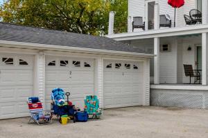 a garage with two chairs and a house at Beachside Condo w Stunning Lake Views in Sheboygan