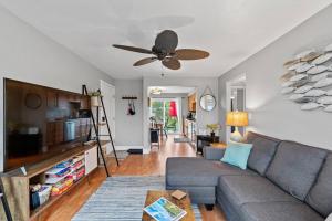 a living room with a couch and a ceiling fan at Beachside Condo w Stunning Lake Views in Sheboygan +62 photos