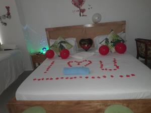 a bed with a heart made out of red balloons at Aqua Garden Building in Nyali
