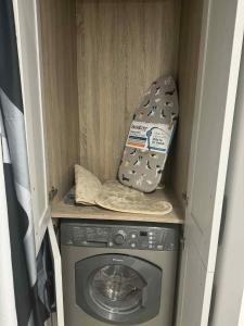 a washing machine with a hat on top of it at The Garden Studio in Dublin