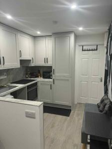 a kitchen with white cabinets and a counter top at The Garden Studio in Dublin