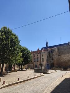 an empty street in front of a building at Le Nid Comtois in Vic-le-Comte