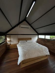 a bedroom with a large bed in a tent at Tiny House in Kuala Terengganu