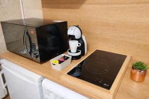 a microwave sitting on top of a kitchen counter at Le Nid Comtois in Vic-le-Comte
