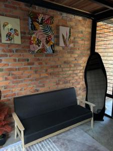 a brick wall with a black bench in a room at Tiny House in Kuala Terengganu