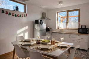 a kitchen with a table with plates and wine glasses at Casa Aluna Duo in Bran