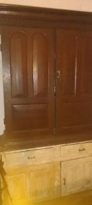 a wooden cabinet in a room with wooden cabinets at Lakeview since 1963 in Pilawala +14 photos