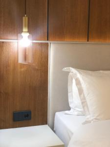 a room with two beds and a light on the wall at Symphony Boutique in Tashkent
