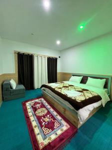 a bedroom with a large bed and a rug at Vajra Inn Pangong in Meruk