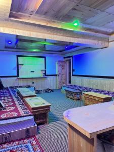 a room with tables and a projection screen in a room at Vajra Inn Pangong in Meruk