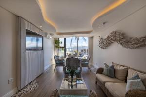 a living room with a couch and a table at Bayview Hotel in Plettenberg Bay