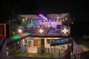 a house with a swimming pool at night at Heavens Hotel in Agra