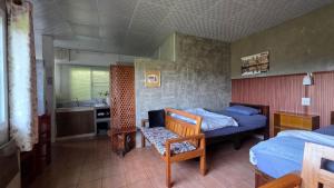 a bedroom with two beds and a table and a chair at JaiSabai Homestay in Mae Ai