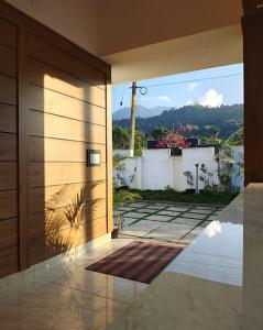 a door to a house with a view of a yard at Tender leaf inn in Koroth