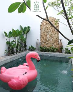 a pink flamingo float in a swimming pool at Sampai Villa Prambanan in Randugunting +7 photos