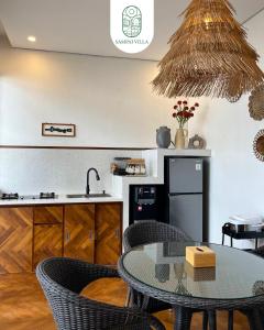 a kitchen and dining room with a table and chairs at Sampai Villa Prambanan in Randugunting