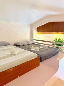a bedroom with two beds at Violegre Homestay - KABLON in General Luna