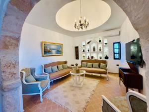 a living room with a couch and a table at Dar Sofien Erriadh Djerba in Erriadh