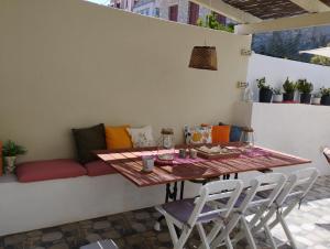 a table and chairs in a patio with a couch at Yalitzi in Symi