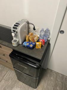 a refrigerator with food and water bottles on a counter at Piccolo Paradiso in Novara +3 photos