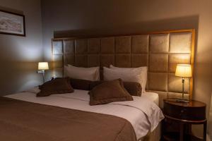 a bedroom with a large bed with two lamps at Cosmonaut in Karagandy +31 photos