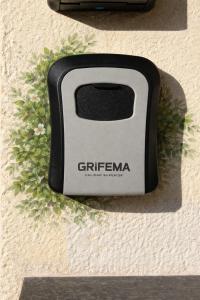a black and white toaster on the side of a wall at Apartment Meringa in Pettenasco +2 photos