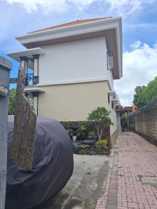a house with a cover on the side of it at Jukung Villas Kuta in Kuta