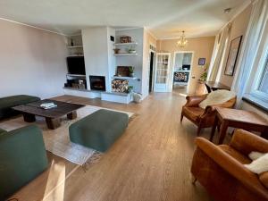 a living room with a couch and a table at Raggio di Sole Villa in Oggebbio