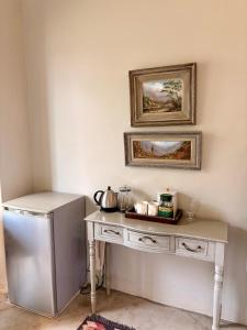 a kitchen with a white table and a refrigerator at Winner in the Overberg in Bredasdorp