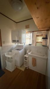 a small kitchen with a sink and a tub at sakurazaka in Tanabe