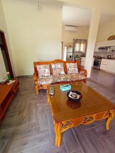 a living room with a couch and a table at Nhambavale Niara House in Chidenguele