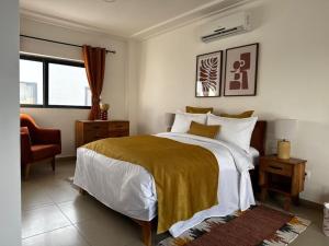 a bedroom with a bed and a chair and a window at Villa EWA in Kika
