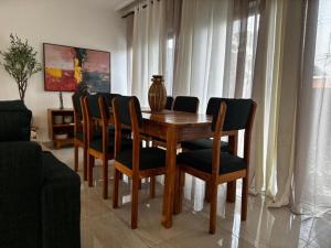 a wooden dining room table and chairs in a room at Villa EWA in Kika