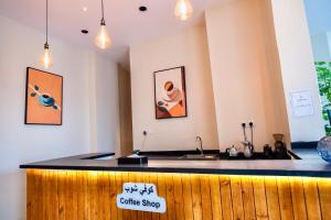 a coffee shop with a counter with a sign on it at W Suites Hotel Sama Abha in Abha