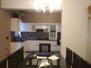 a kitchen with a dining room table and a chandelier at Negombo New Villa in Negombo