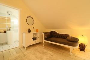 a living room with a couch and a mirror at Zodia Craiului in Peştera