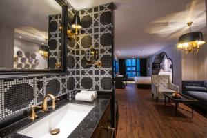 a bathroom with a sink and a living room at Orange Crystal Hotel Nanjing Museum in Nanjing +62 photos