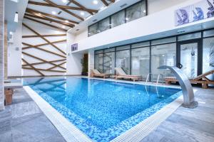 a pool in a building with a swimming pool at Hotel Nais Nis Autoput in Niš