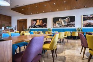 a dining room with a long table and chairs at Hotel Nais Nis Autoput in Niš +56 photos